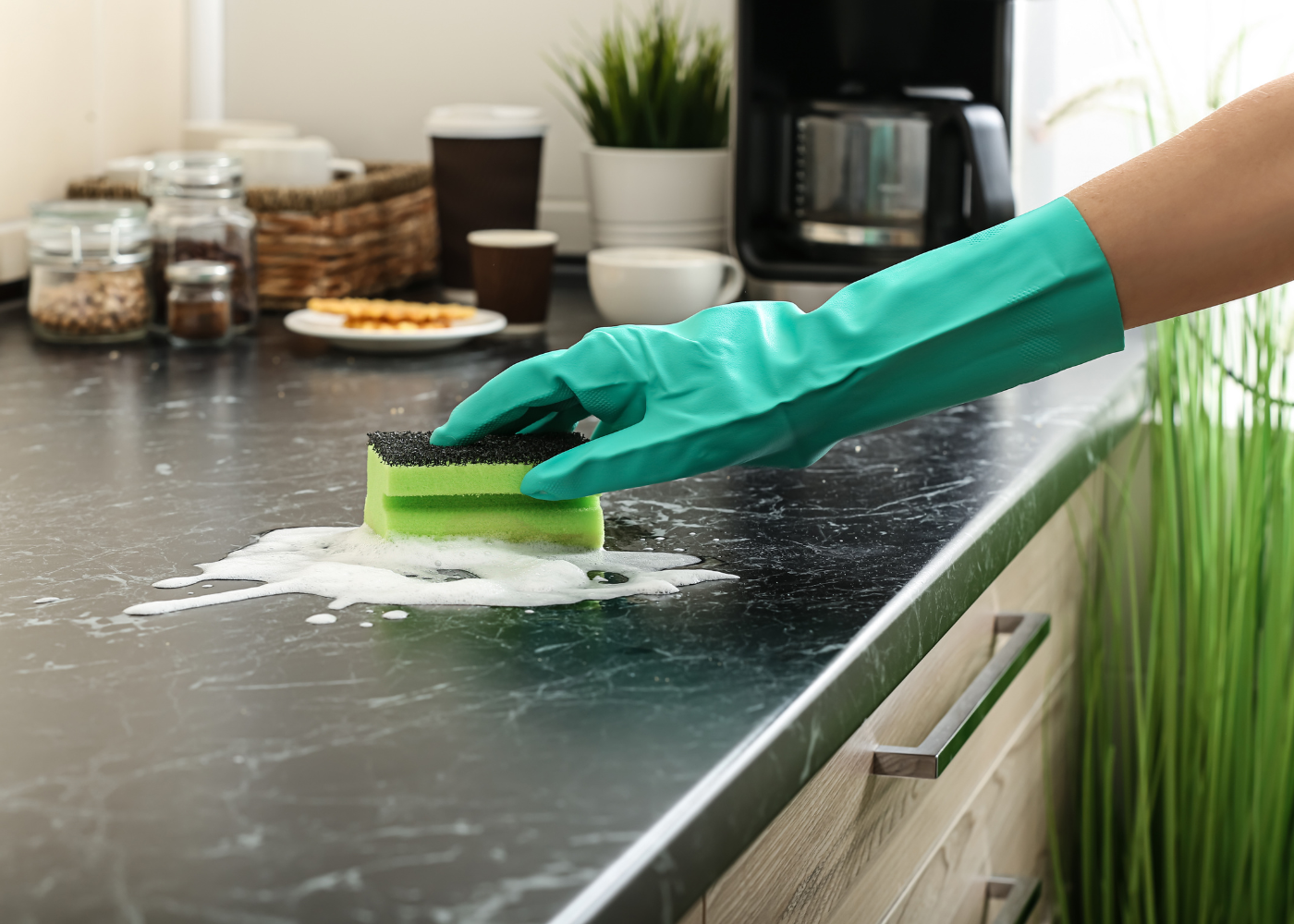 a hand in a glove cleaning a countertop