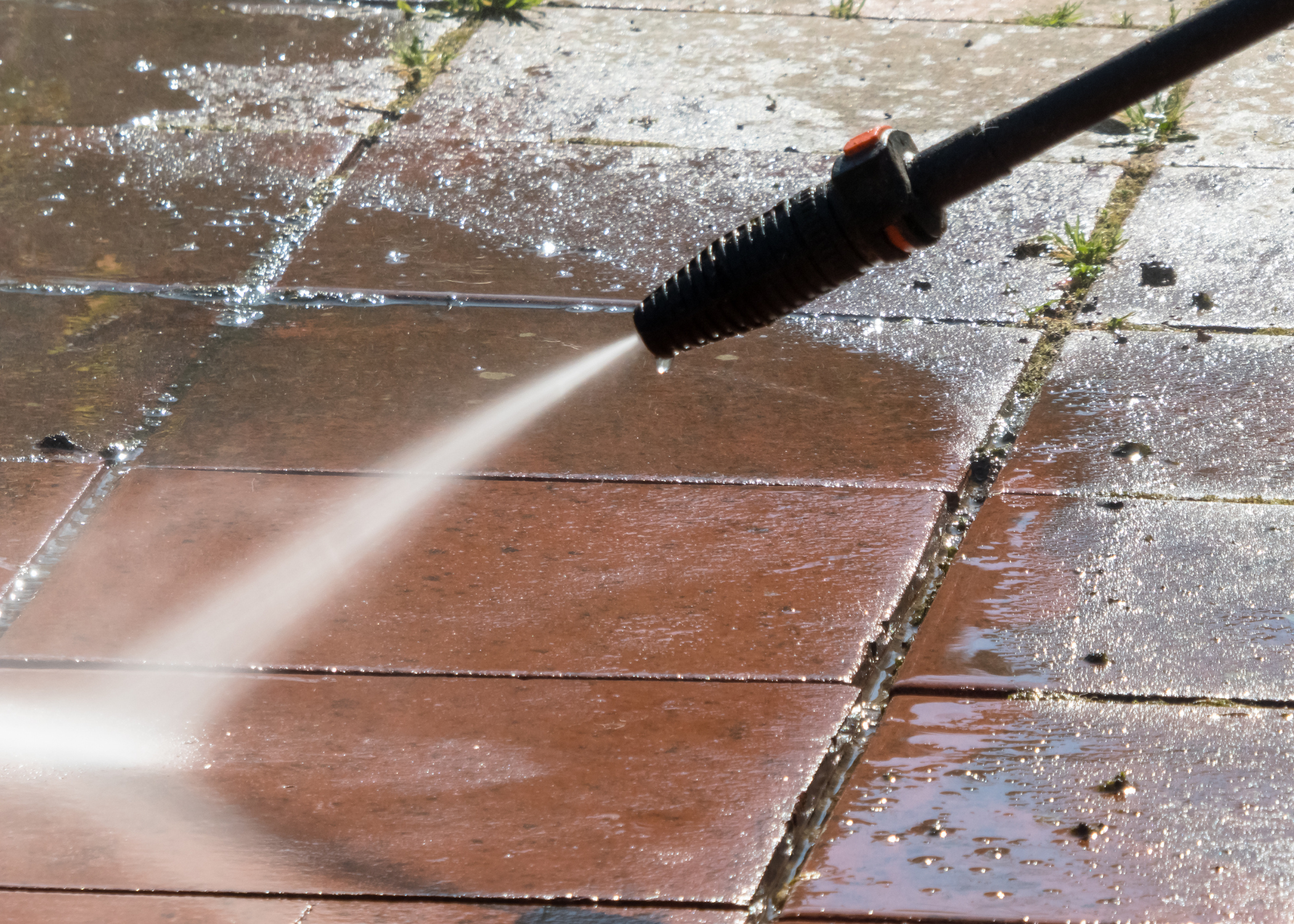 a close up of a hose spraying water on a tile floor